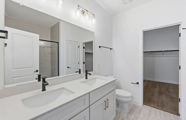 a bathroom with a sink toilet and shower