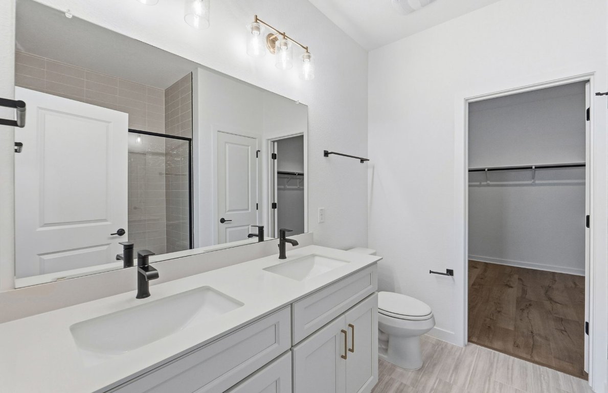 290 Begonia Street Buda, TX 78610 - Photo 9 of 25 a bathroom with a sink toilet and shower