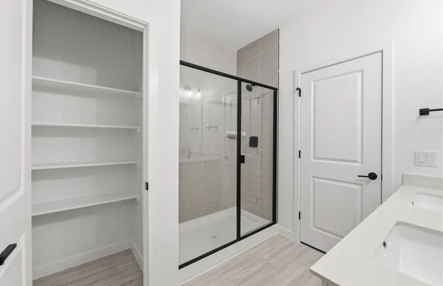 a bathroom with a shower and a glass door
