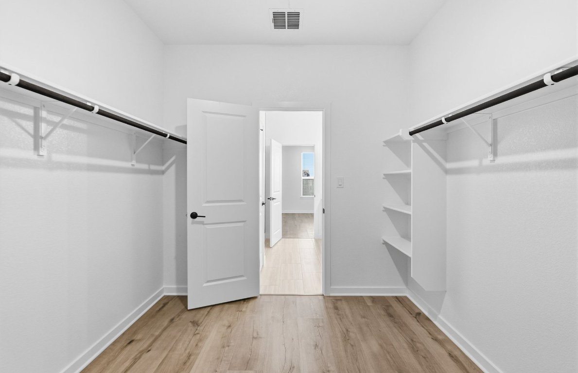 290 Begonia Street Buda, TX 78610 - Photo 11 of 25 a view of wooden floor in a room