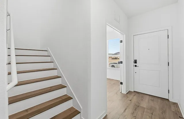 a view of an entryway with wooden floor