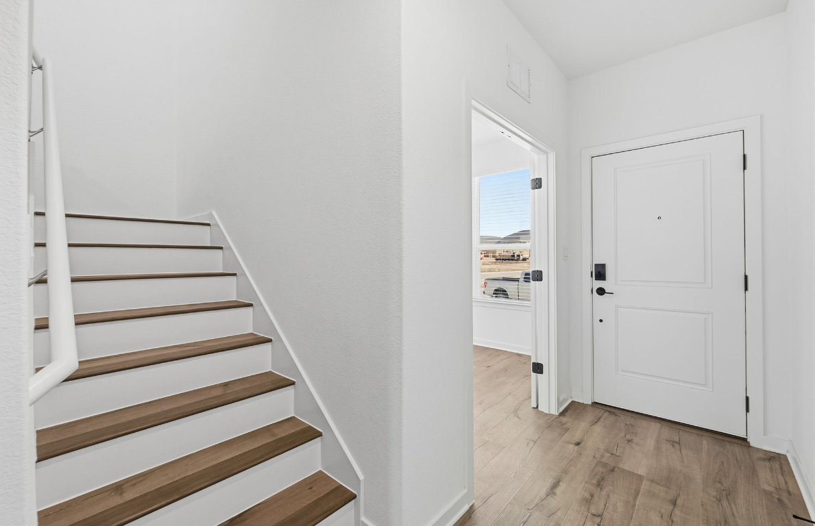 290 Begonia Street Buda, TX 78610 - Photo 13 of 25 a view of an entryway with wooden floor
