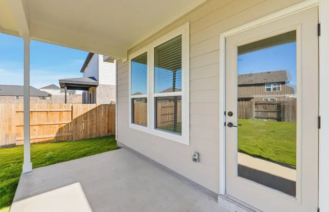 a view of a big house with a big yard and large trees