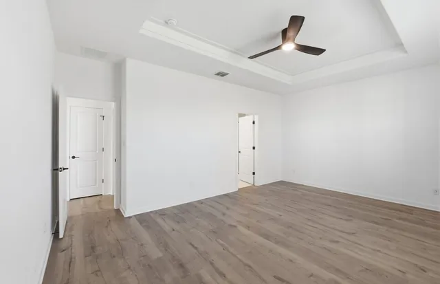 a view of an empty room with wooden floor