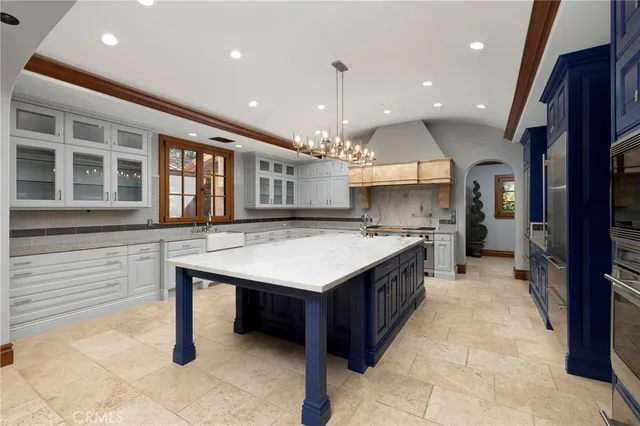 a view of a hall with a fireplace and a chandelier