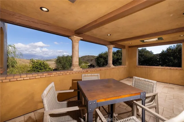 a living room with a bed and a chandelier
