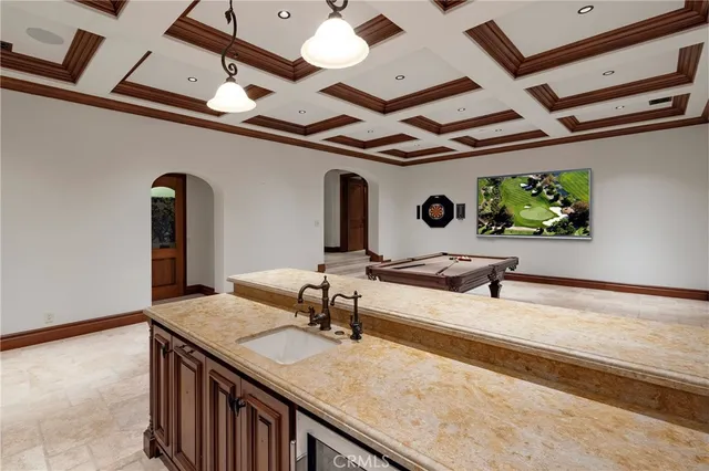 a kitchen with a sink a counter top space and a stove top oven
