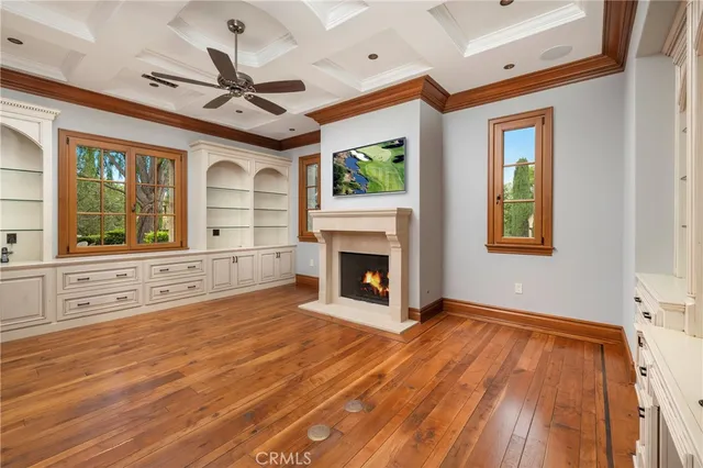 a view of an empty room with a fireplace and a window