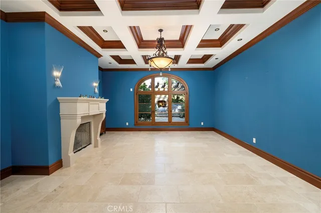 a view of a livingroom with a fireplace and a chandelier