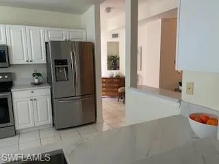 a kitchen with a refrigerator and a sink
