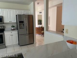 600 Diamond Circle, Unit 607 Naples, FL 34110 - Photo 5 of 12 a kitchen with a refrigerator and a sink