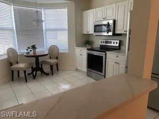 a kitchen with stainless steel appliances a stove a sink a microwave and cabinets