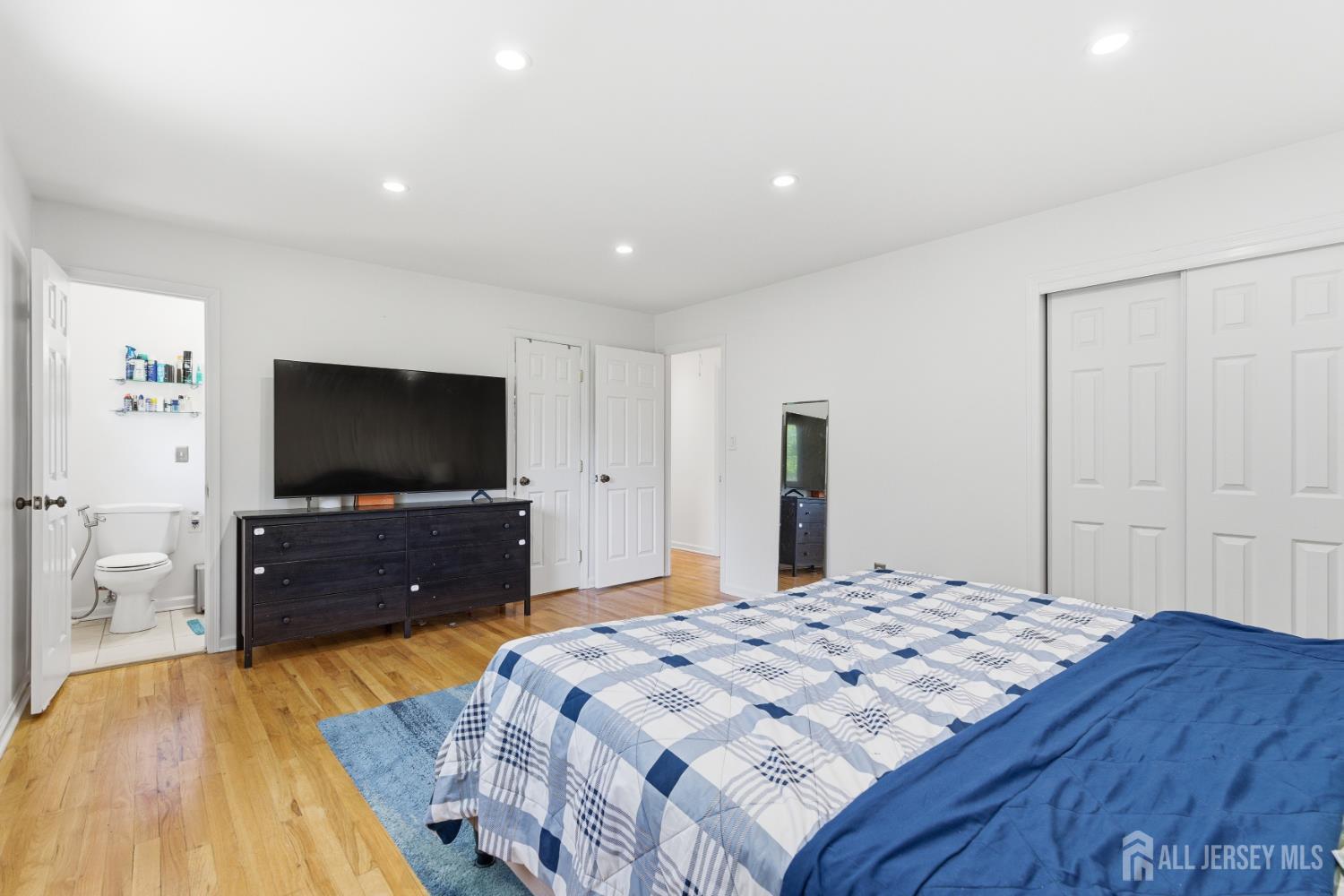 213 Normandy Road Edison, NJ 08820 - Photo 28 of 45 a bedroom with a bed and a flat screen tv