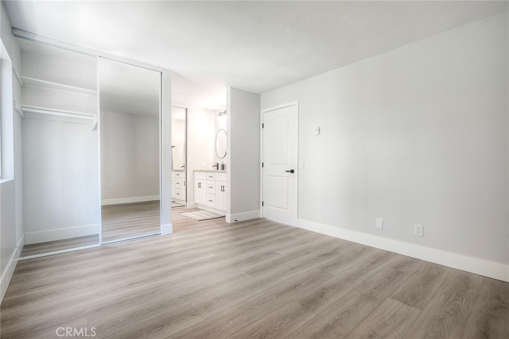 149 West Glaucus Street, Unit D Encinitas, CA 92024 - Photo 14 of 29 an empty room with wooden floor & closet area