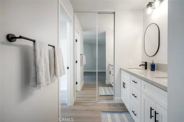 a spacious bathroom with a double vanity sink a mirror and a shower