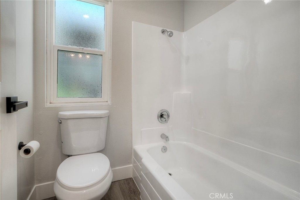 149 West Glaucus Street, Unit D Encinitas, CA 92024 - Photo 18 of 29 a white toilet sitting next to a tub