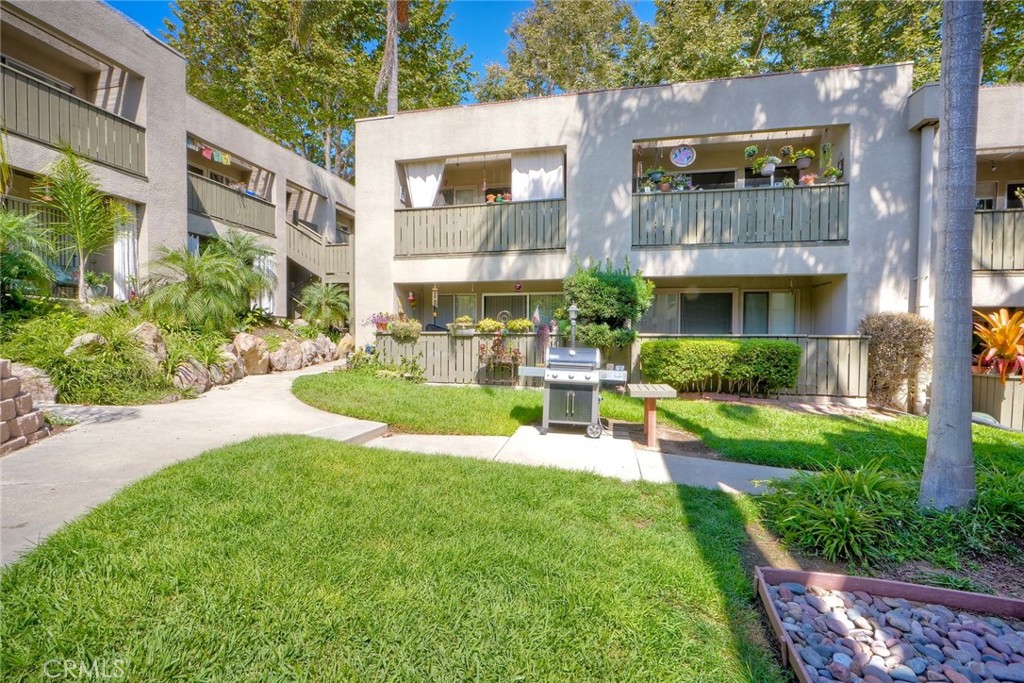 149 West Glaucus Street, Unit D Encinitas, CA 92024 - Photo 24 of 29 a view of a building with a yard and sitting area