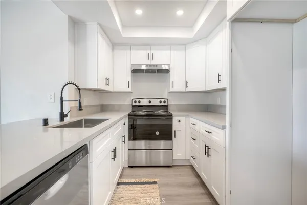 a kitchen with stainless steel appliances granite countertop a stove and a sink