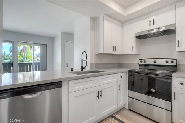 a kitchen with stainless steel appliances white cabinets and a granite counter tops