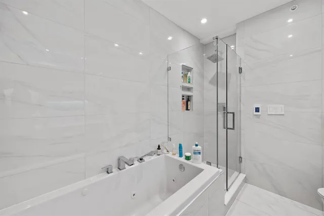 a bathroom with a bathtub and a shower