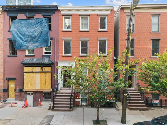 a front view of a building with garden