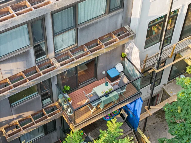 a view of a chairs and table in a balcony