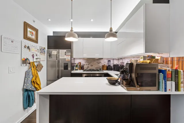 a kitchen with a sink a stove and a refrigerator