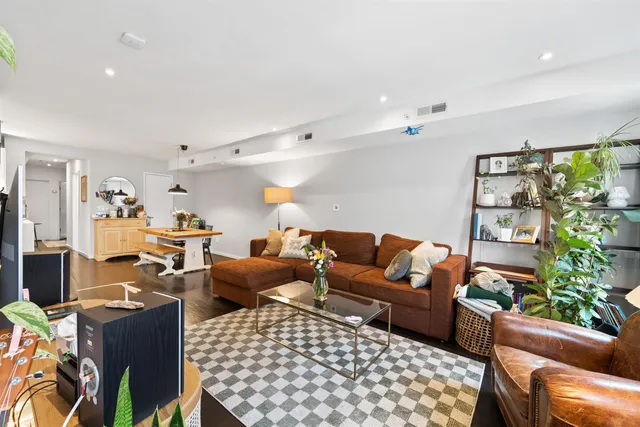 a living room with furniture a rug and a flat screen tv