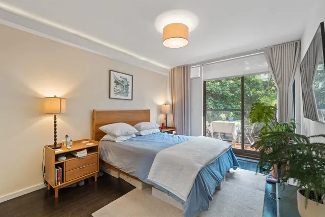 a bedroom with a bed and a large window