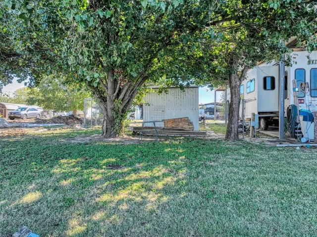 a view of backyard of house with green space