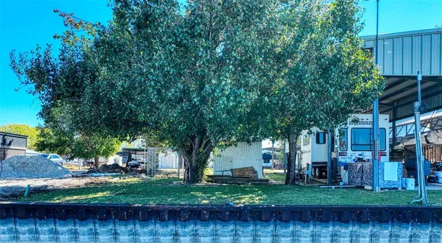a backyard of a house with lots of green space table and chairs