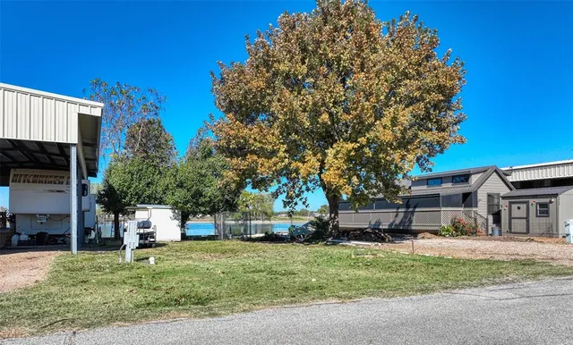 a small house in middle of the green field