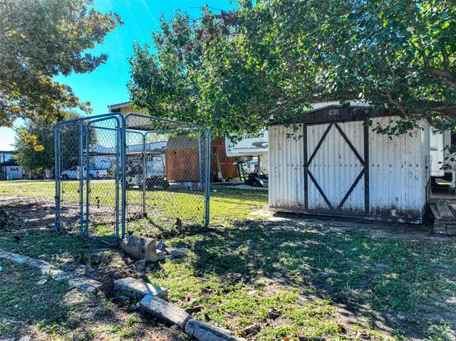 a view of a backyard with a garden and entertaining space