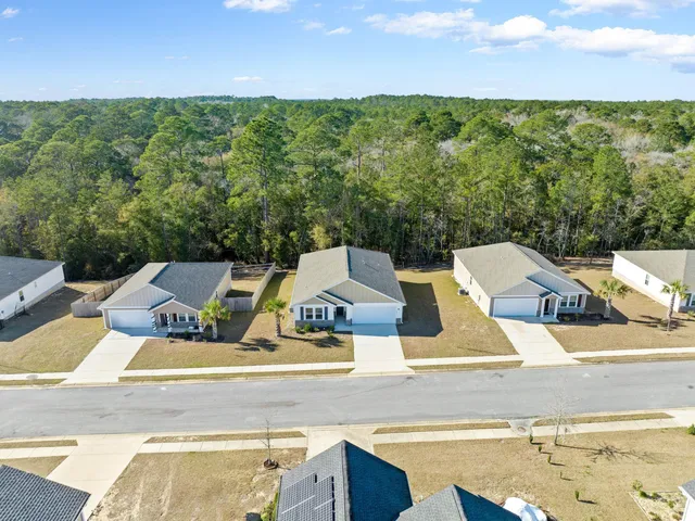 a view of an outdoor space with seating area and trees in the background