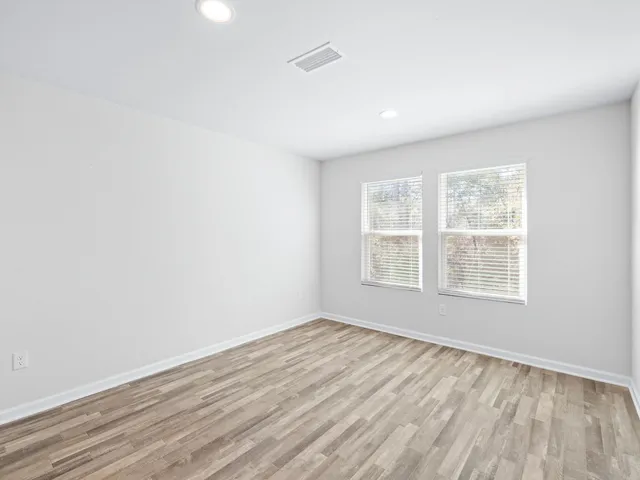 a view of a room with wooden floor and closet