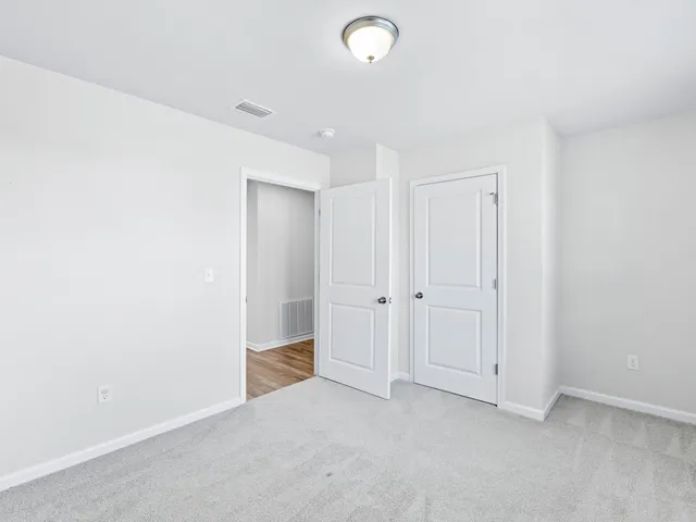 a spacious bedroom with a large bed and a window
