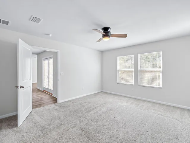 an aerial view of residential houses with outdoor space and trees all around