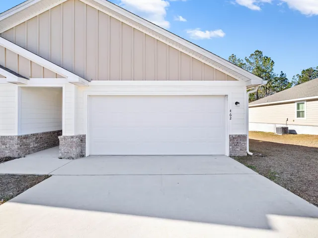 an aerial view of a house with swimming pool and lake view
