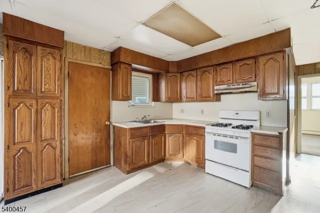 a kitchen with stainless steel appliances granite countertop a refrigerator stove and sink