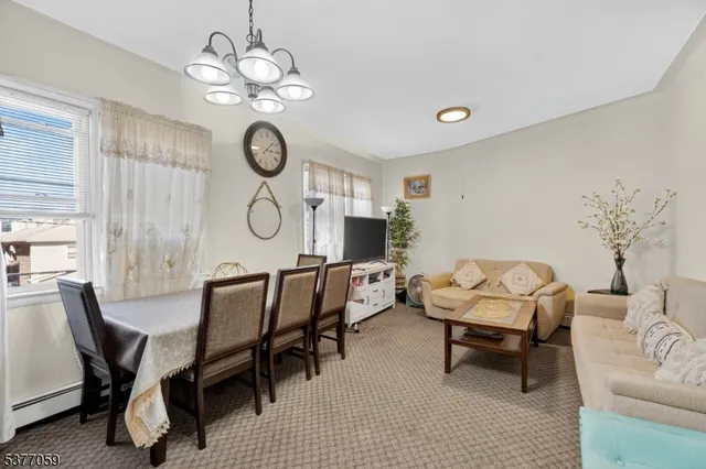 a view of a dining room with furniture and chandelier