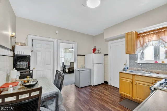 a kitchen that has a lot of cabinets a sink and appliances in it