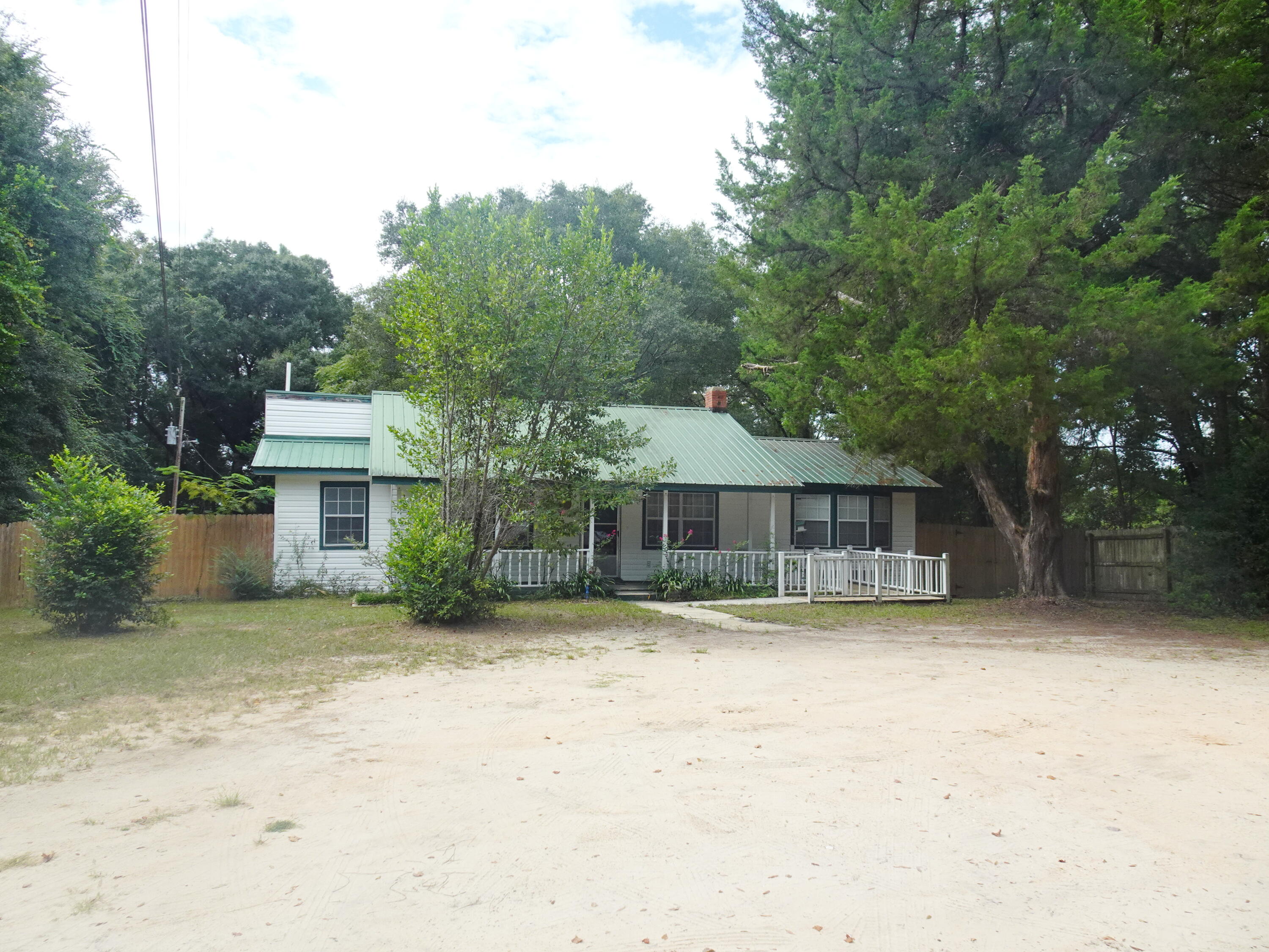 195 Heather Lane DeFuniak Springs, FL 32433 - Photo 1 of 20 a front view of a house with a yard and garage