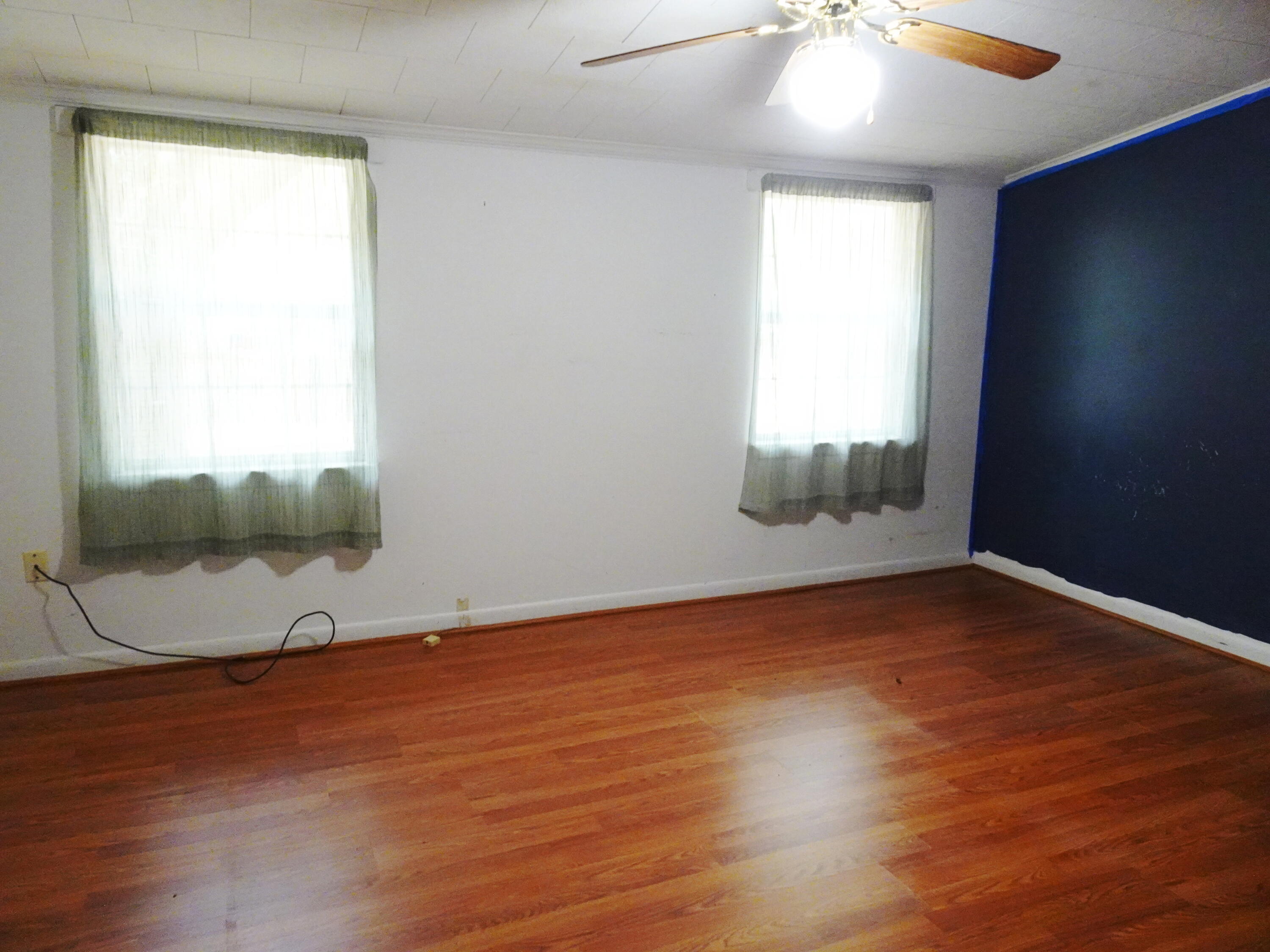 195 Heather Lane DeFuniak Springs, FL 32433 - Photo 13 of 20 an empty room with wooden floor and windows