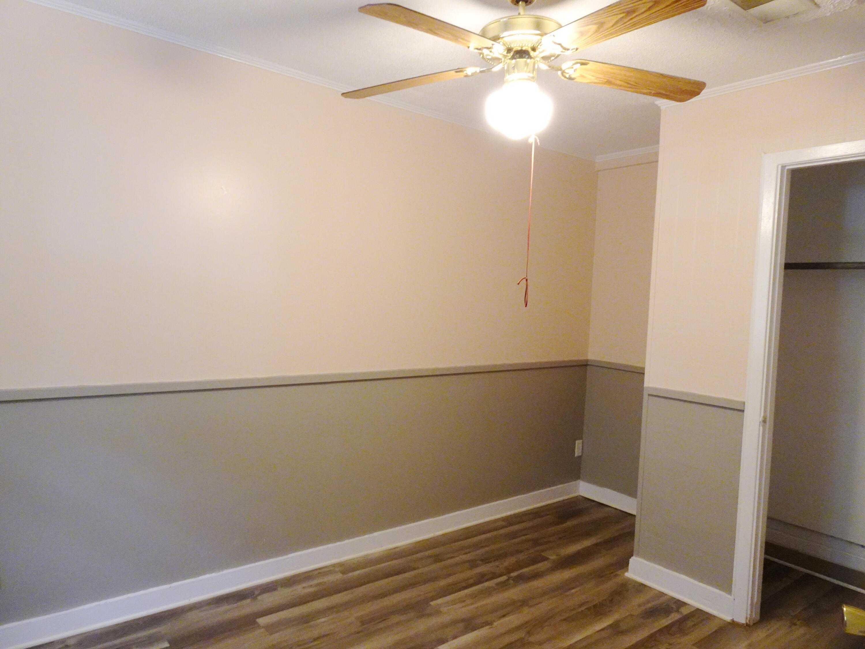 195 Heather Lane DeFuniak Springs, FL 32433 - Photo 9 of 20 a view of a room with wooden floor and fan