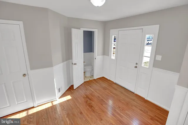 a view of empty room with wooden floor