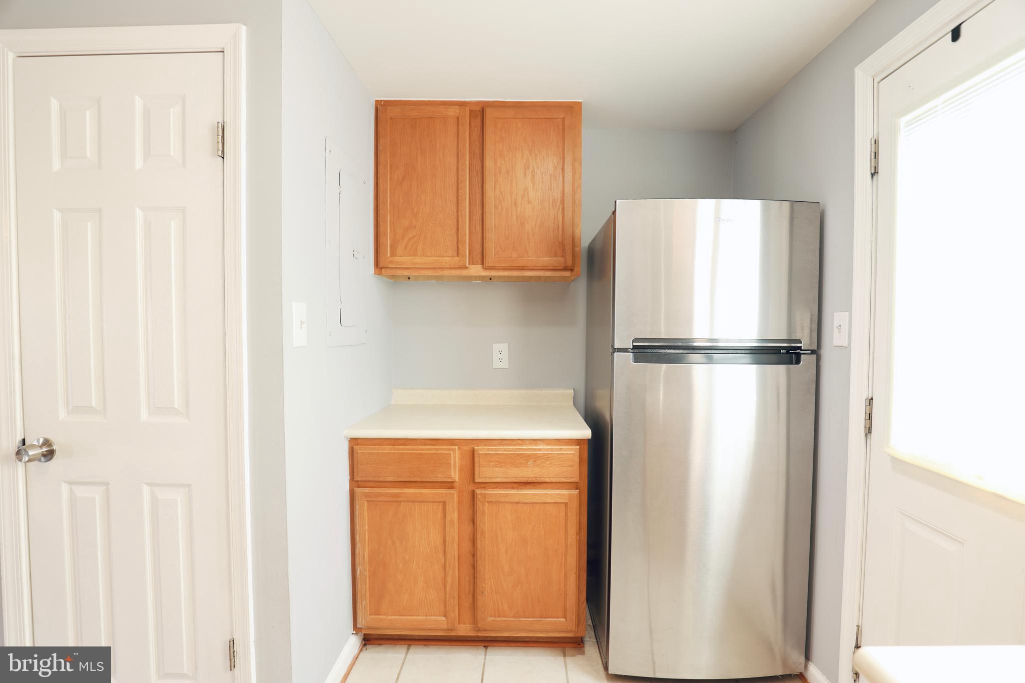 4393 Pembrook Village Drive, Unit 84 Alexandria, VA 22309 - Photo 15 of 38 a close view of a refrigerator in kitchen with stainless steel appliances wooden cabinet