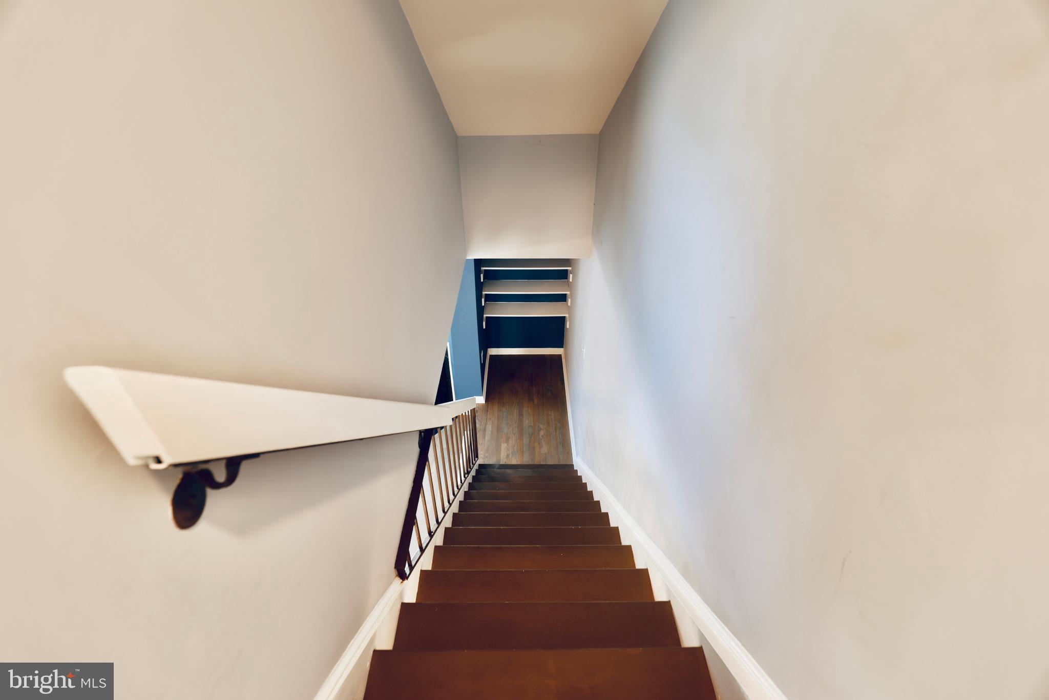 4393 Pembrook Village Drive, Unit 84 Alexandria, VA 22309 - Photo 19 of 38 a view of a hallway with wooden floor and staircase
