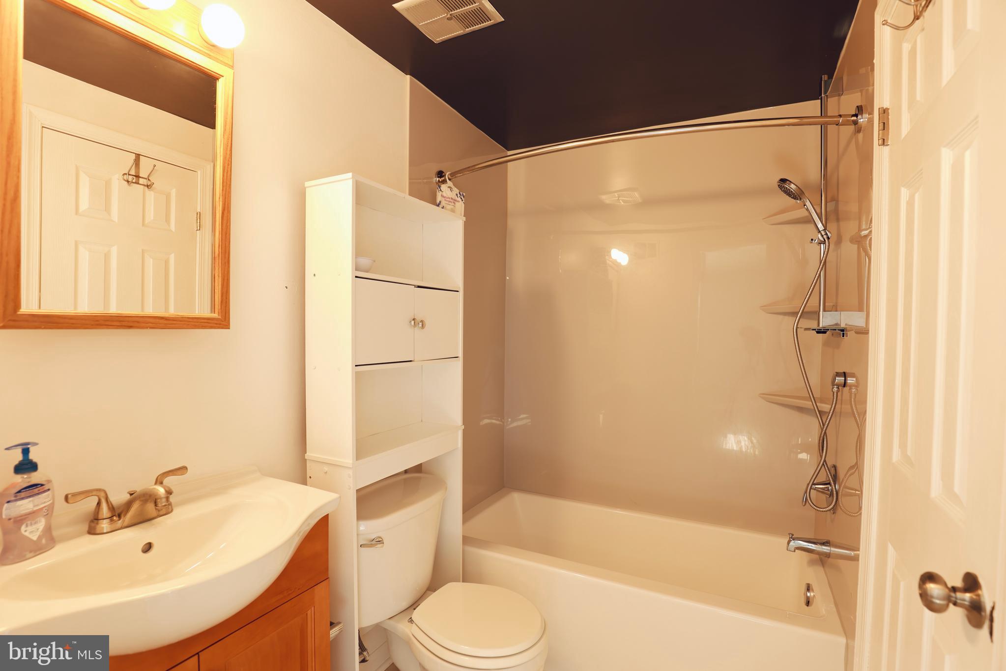 4393 Pembrook Village Drive, Unit 84 Alexandria, VA 22309 - Photo 22 of 38 a bathroom with a sink toilet and shower