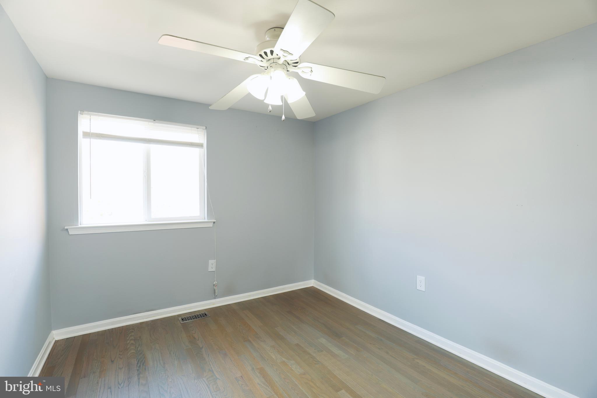 4393 Pembrook Village Drive, Unit 84 Alexandria, VA 22309 - Photo 23 of 38 an empty room with wooden floor fan and windows