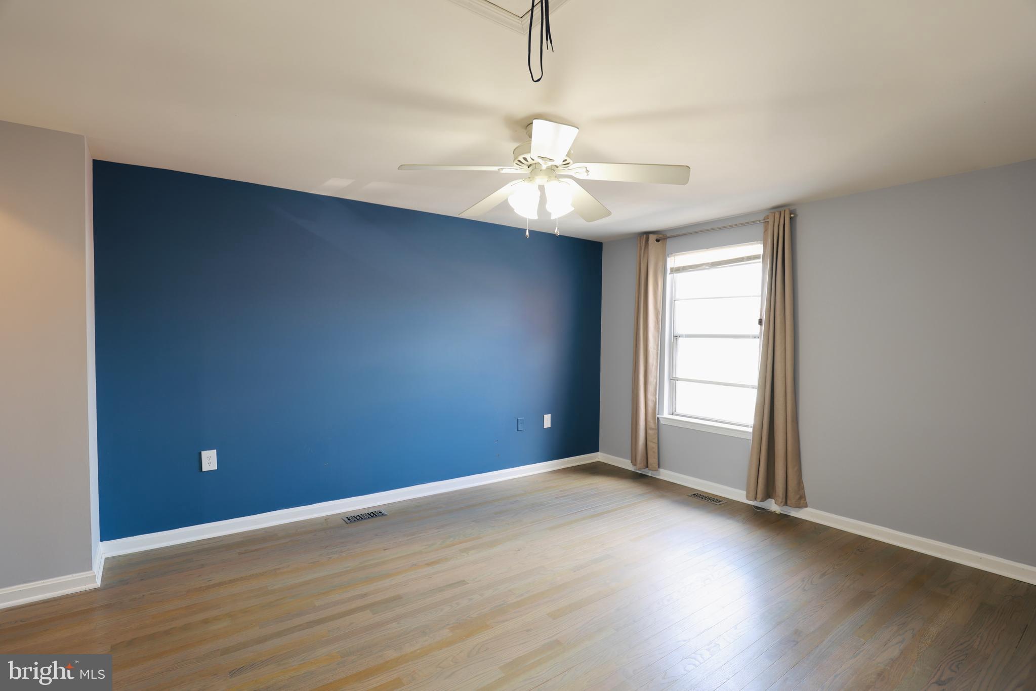 4393 Pembrook Village Drive, Unit 84 Alexandria, VA 22309 - Photo 26 of 38 an empty room with wooden floor and windows